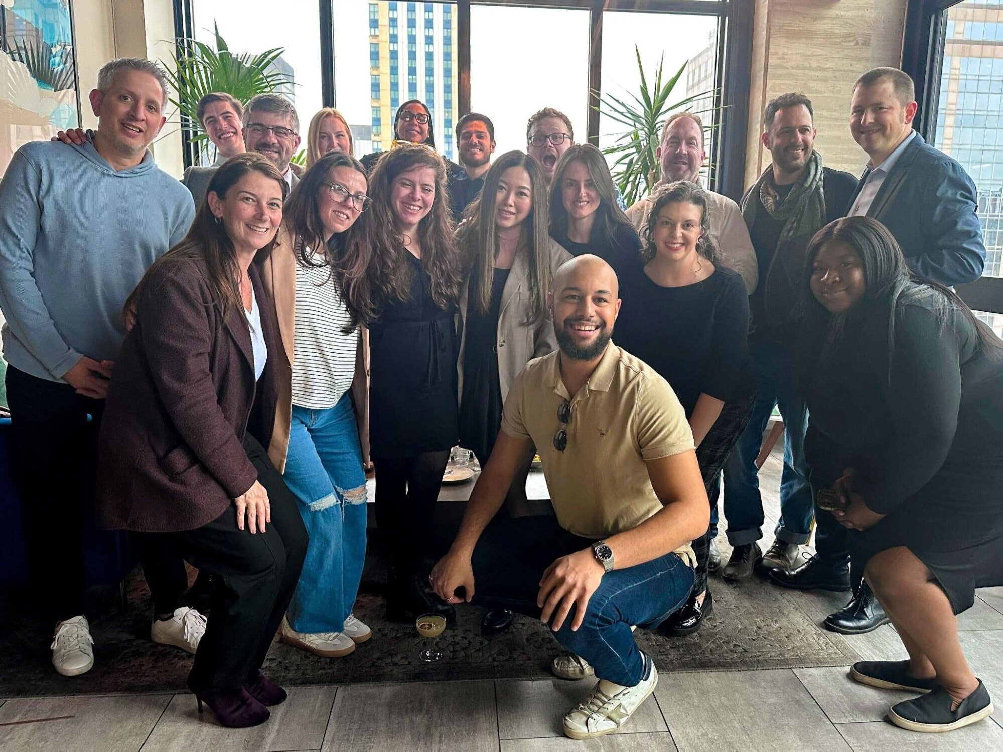 Augury team members pose for a group photo during a rooftop happy hour event.