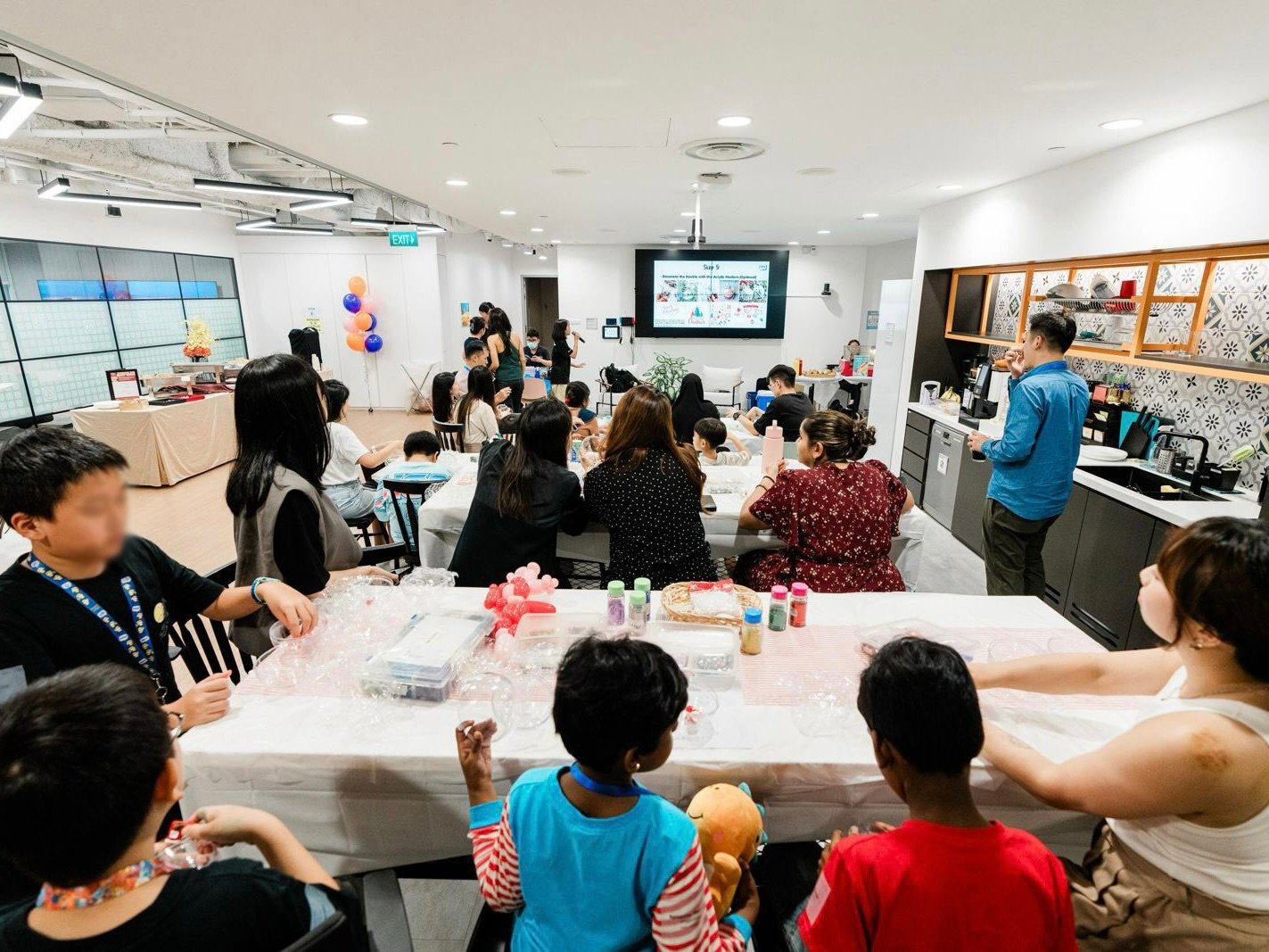 Parents and children work on crafts together during Braze’s Take Your Kids to Work Day celebrations.