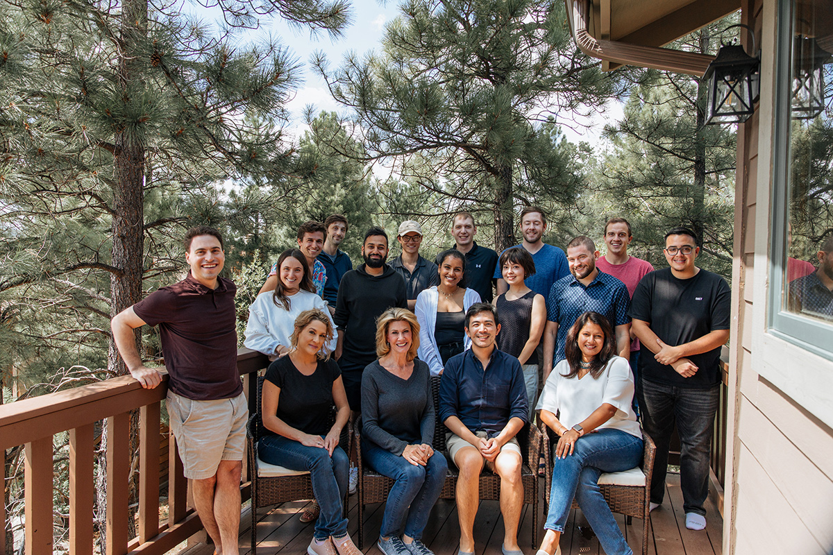 Chapter team members outside of a cabin in the woods