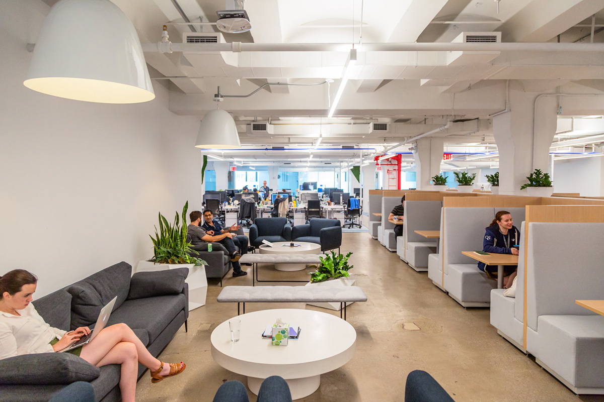 Flatiron team members working in booths in the office