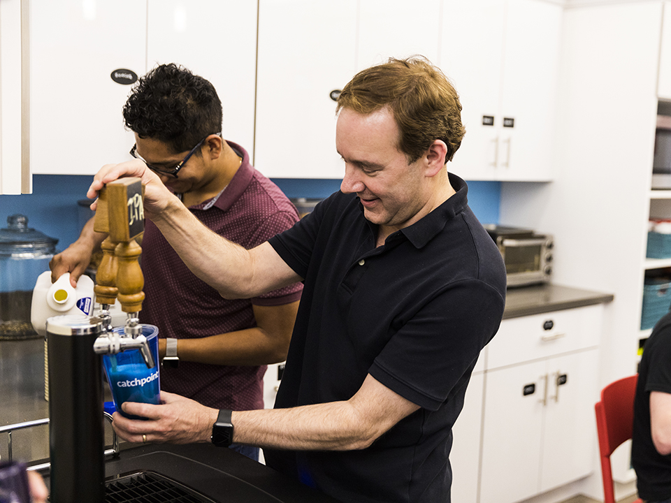 VP of Product, Matt enjoys a beer in the office with his team