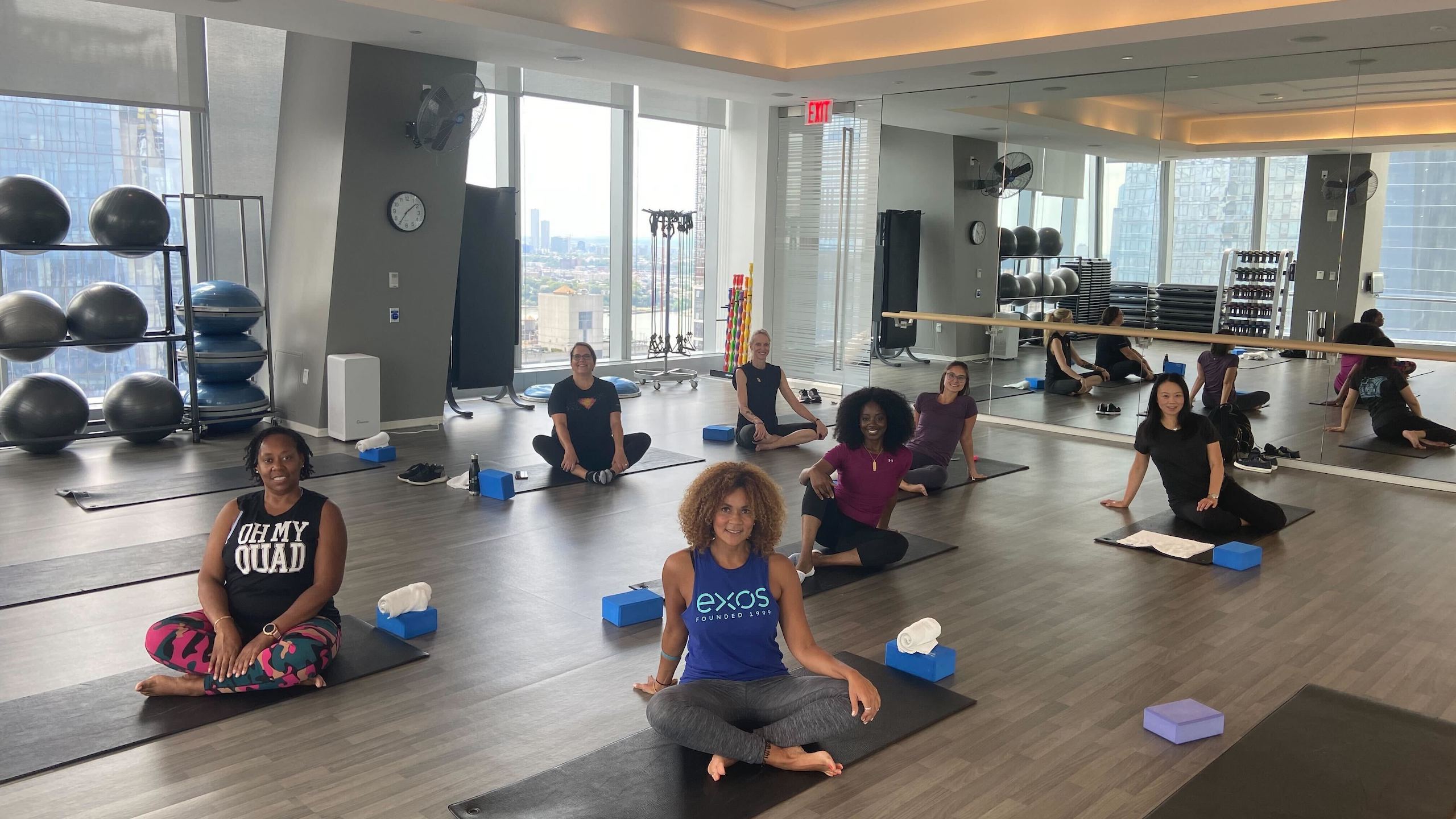 Warner Bros Discovery team members exercise in a yoga studio. 