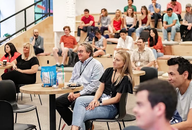 A group of Narmi employees attend a company meeting.