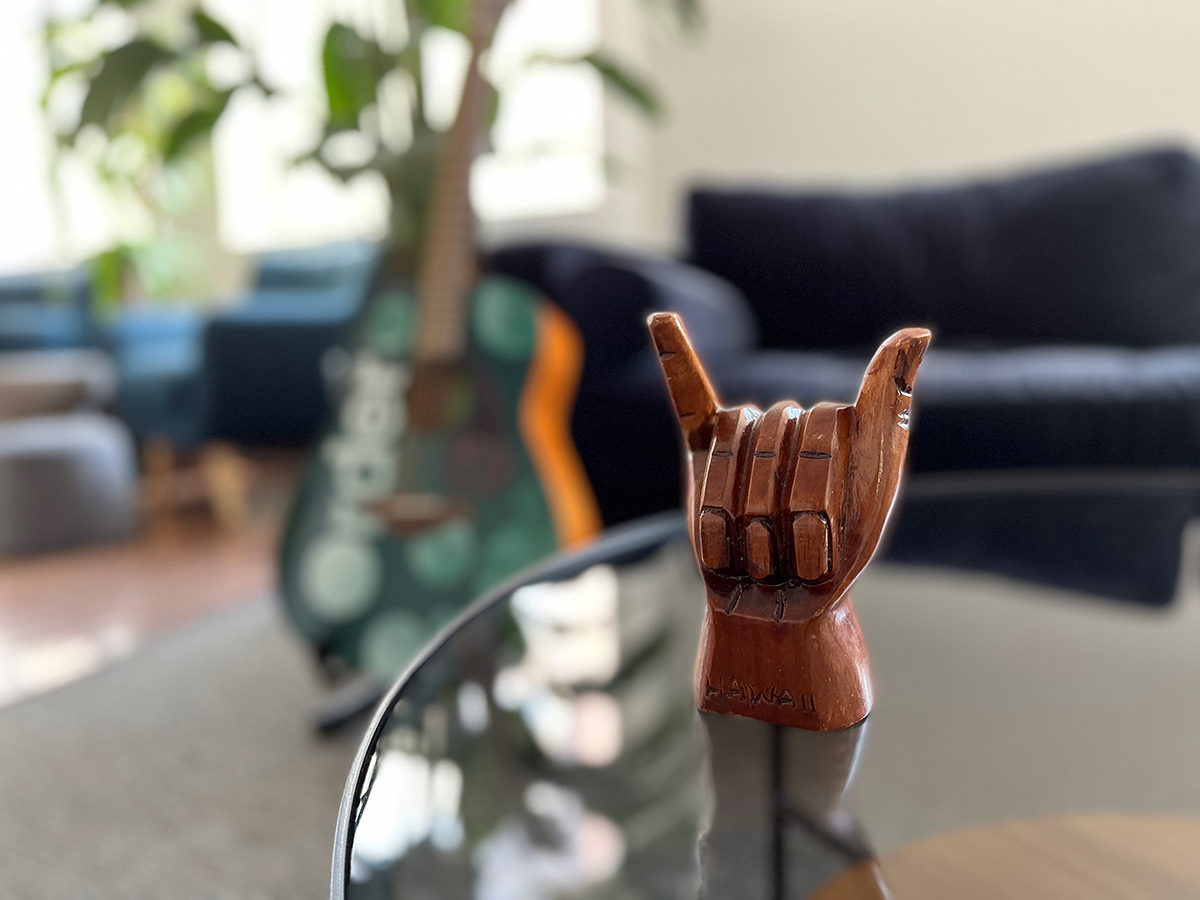 Table in the Order office with a wooden hand on it showing the shaka sign