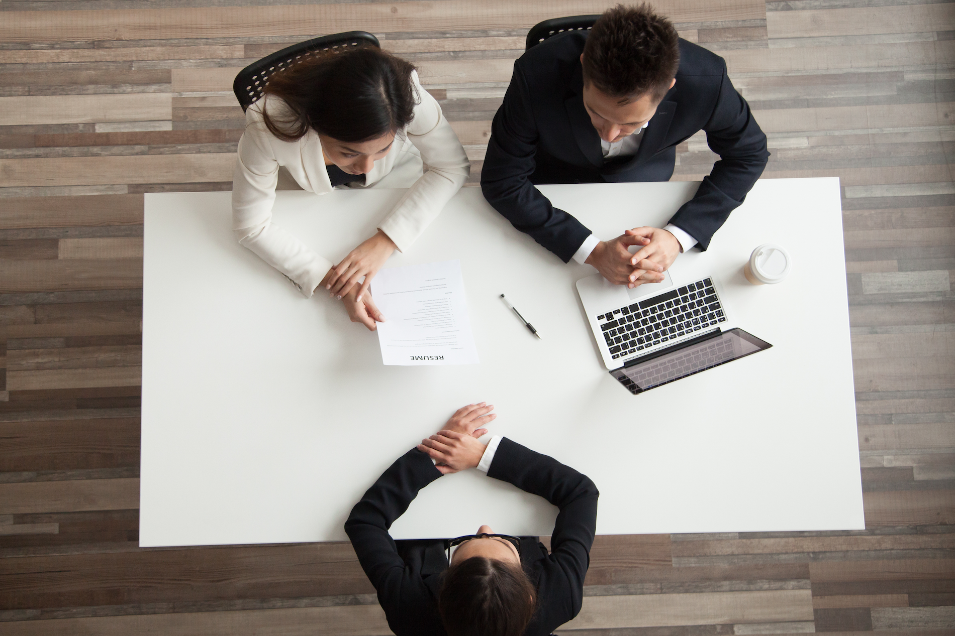 Hr managers interviewing female job applicant, recruiters listen to candidate answering questions at hiring negotiations, recruiting and staffing, making first impression concept, top view from above