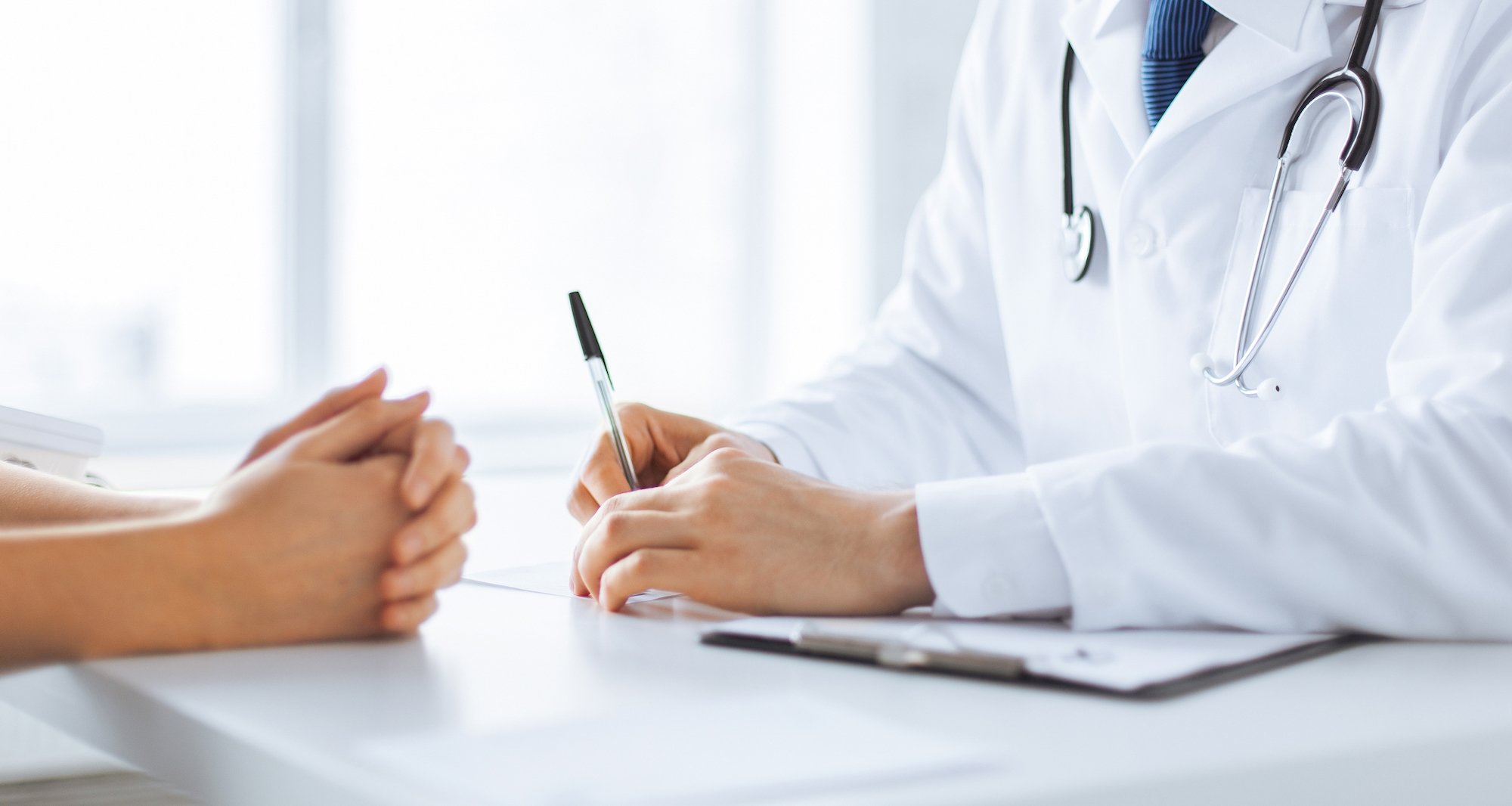 A doctor converses with a patient.