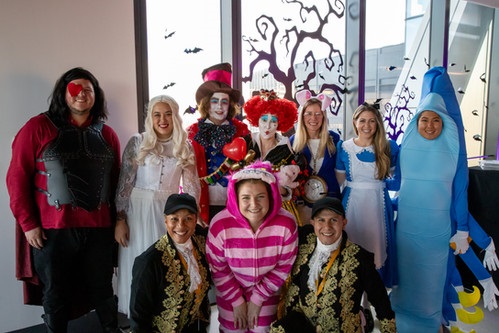 Group photo of people in costumes at IEX’s Friends & Family Fest. 