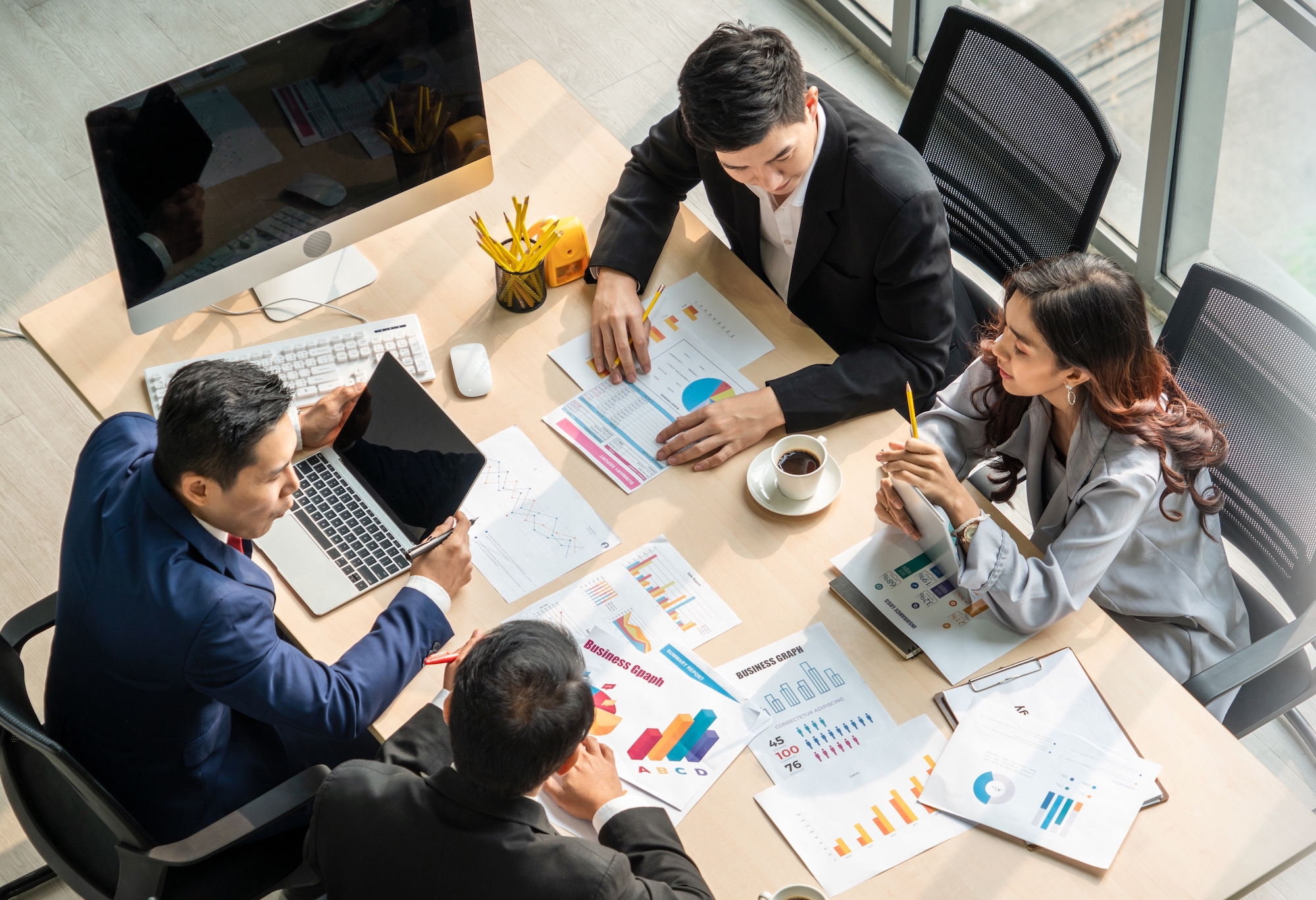 An image depicting employees working in an office is shown.