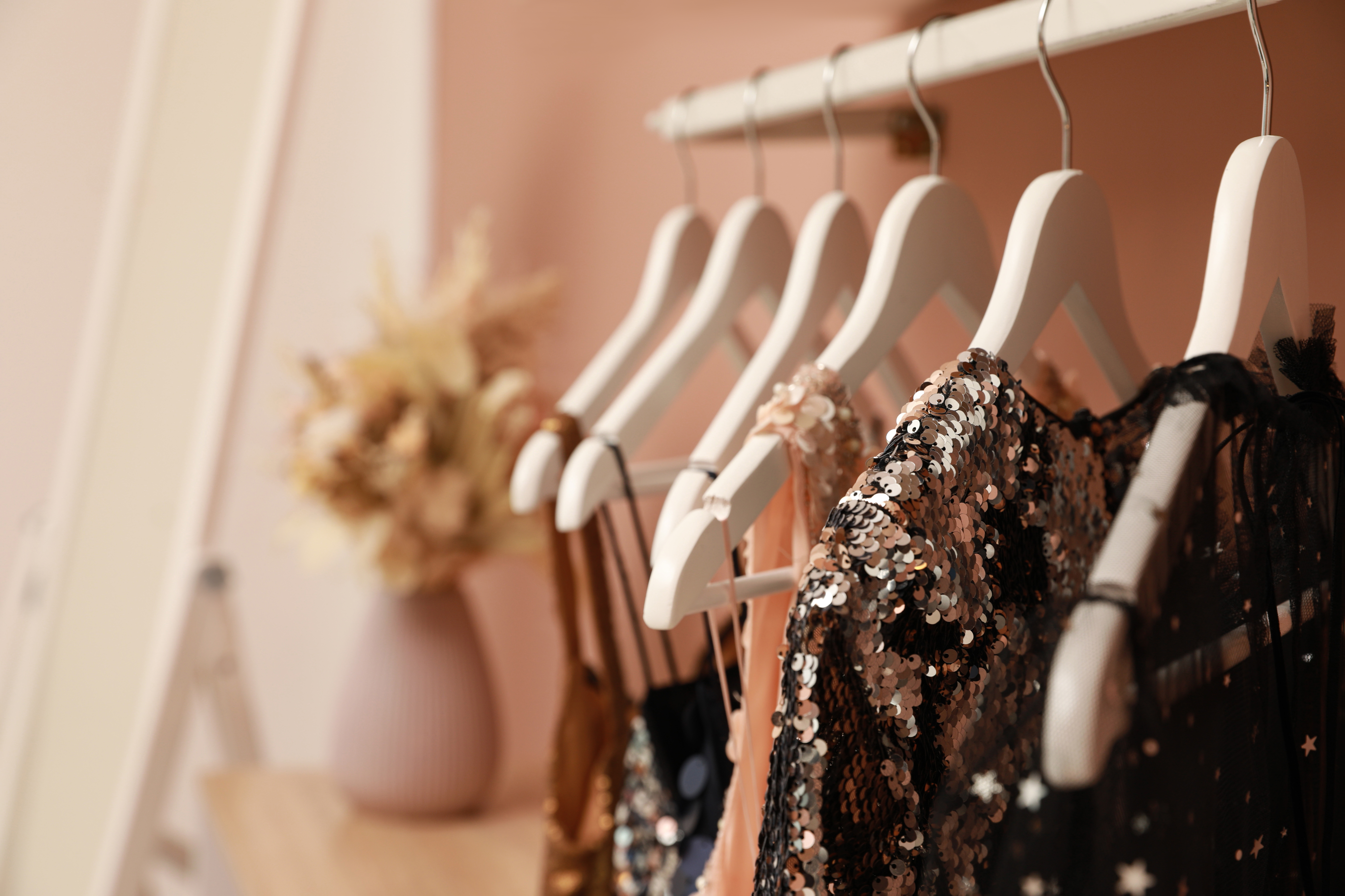 A close-up view of a series of dresses on hangers